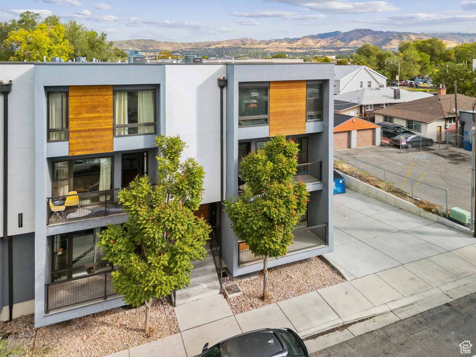 Contemporary house featuring a mountain view, stucco siding, and a residential view