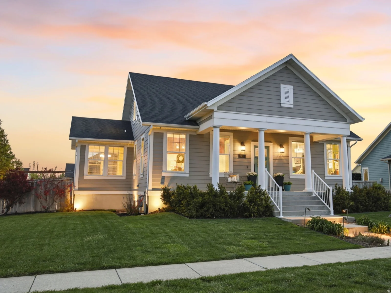 View of front of home with a porch and roof with shingles
