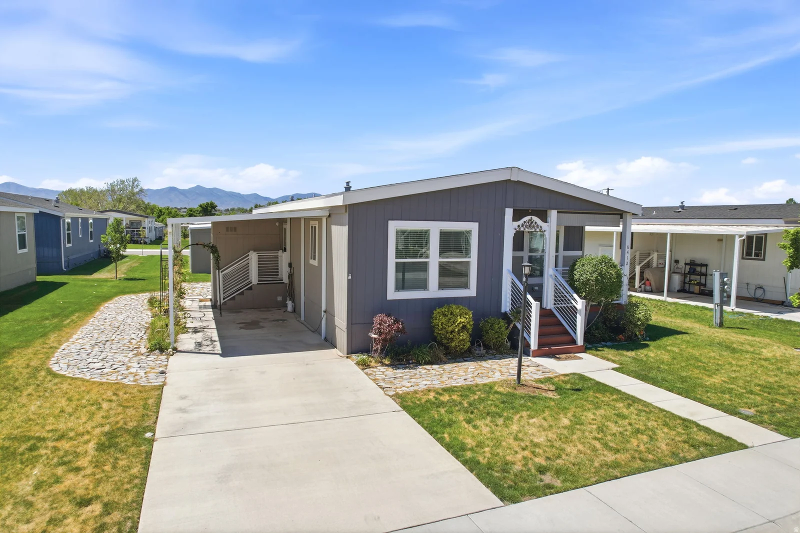 Light gray siding exterior with a covered carport
