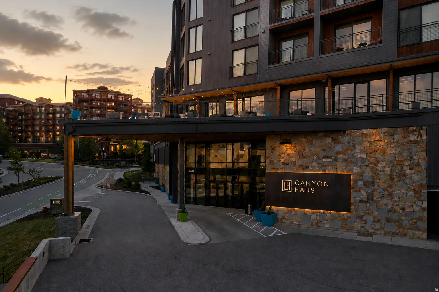 Modern building facade featuring a stone veneer entrance and large glass panels