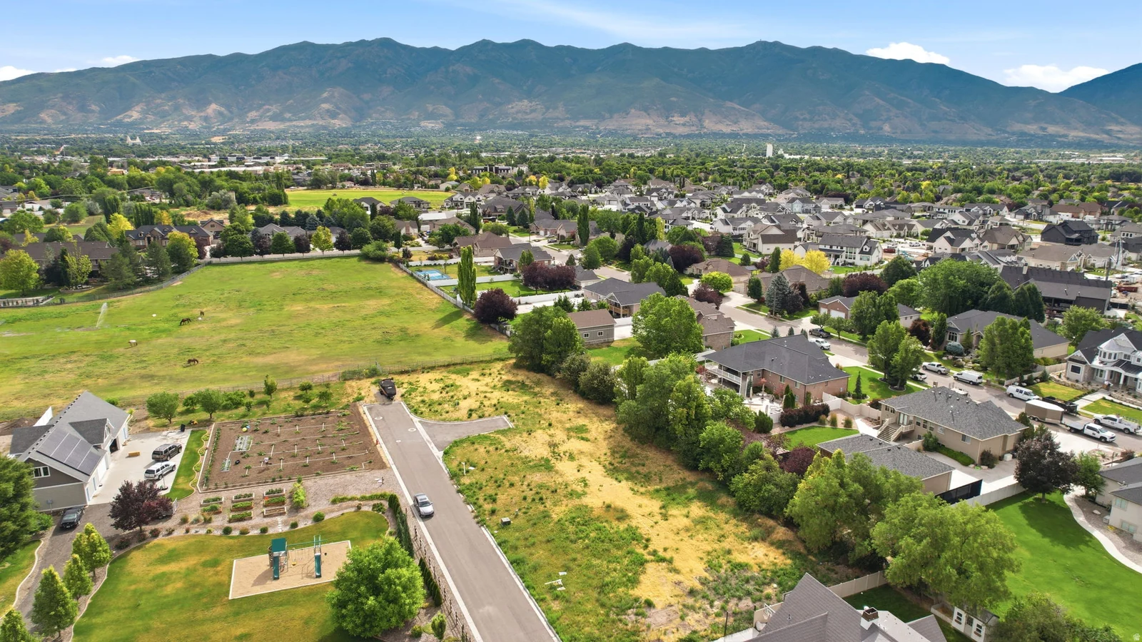 Expansive community featuring established residences, paved streets, abundant green spaces, and mature trees