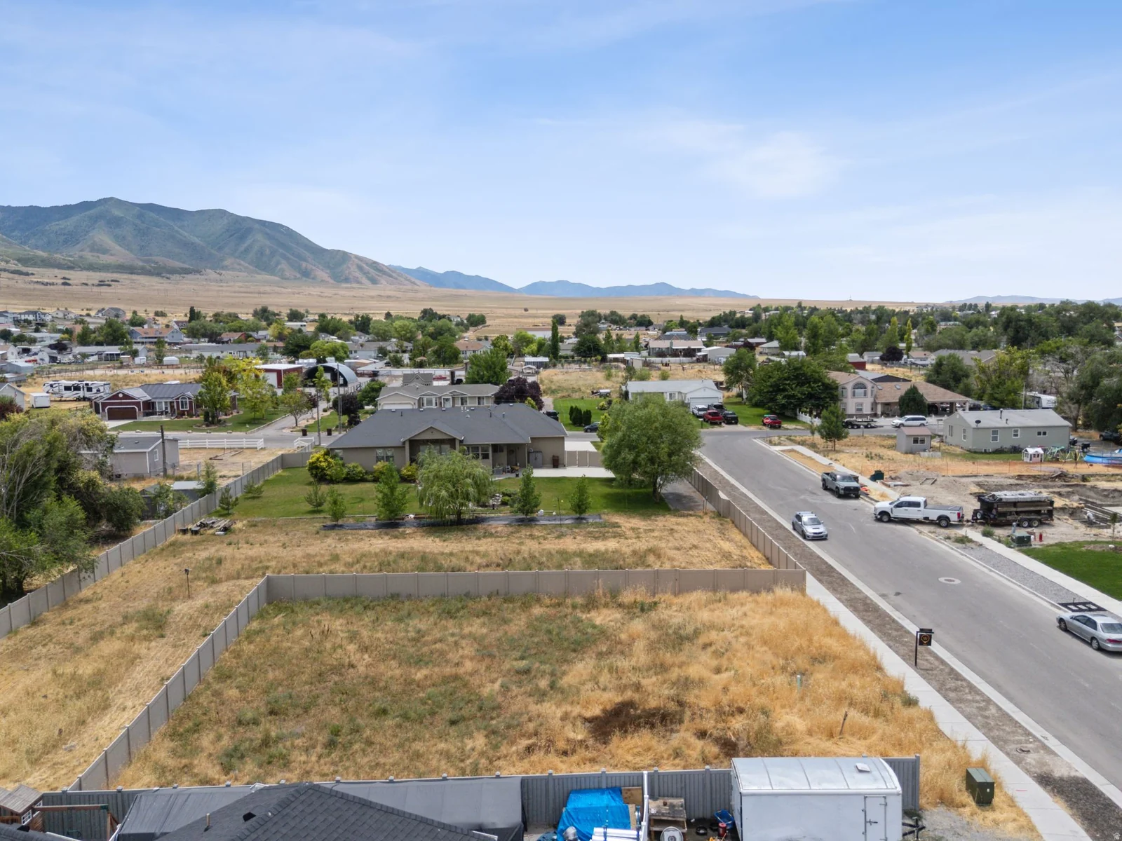 Expansive undeveloped lot with existing perimeter fencing and street frontage