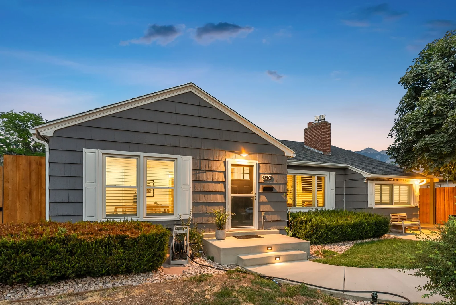 Gray shingle siding with white window shutters