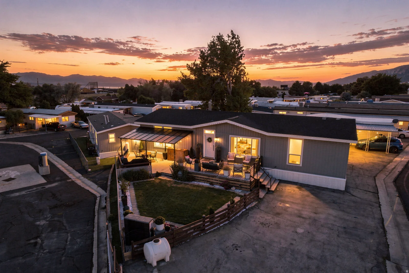 Exterior featuring a covered patio, defined yard space, and a paved driveway