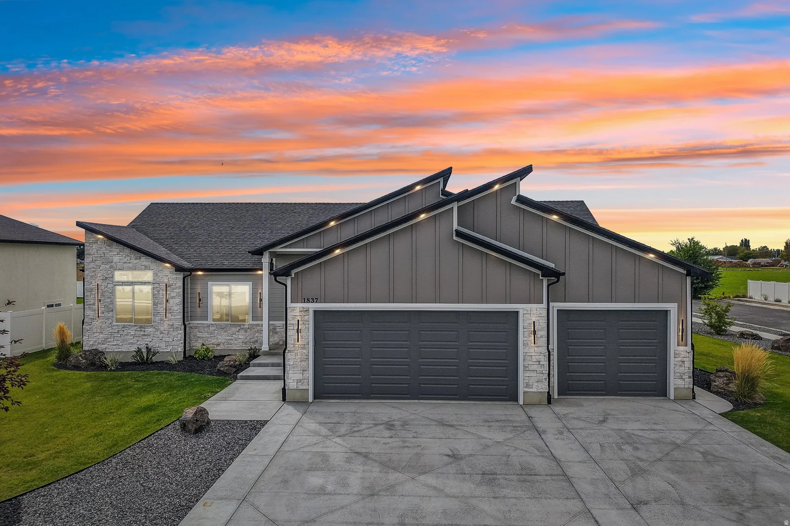Contemporary exterior featuring stone veneer and vertical siding